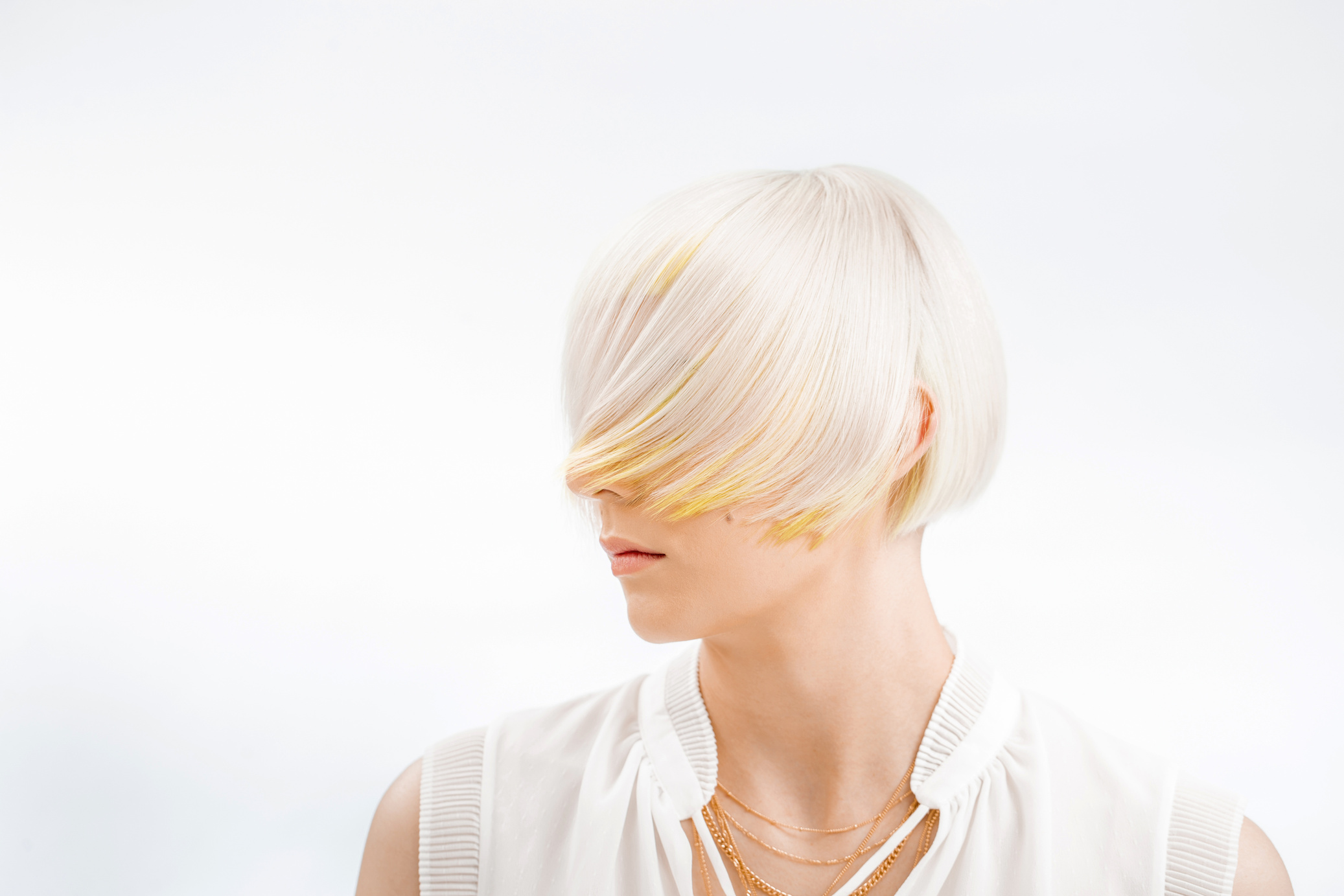 Portrait of Fashionable Young Woman With Bleached Hair Covering Her Face